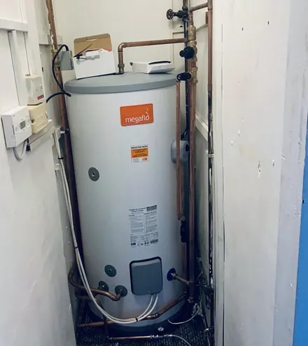 New unvented hot water cylinder fitted in a cupboard