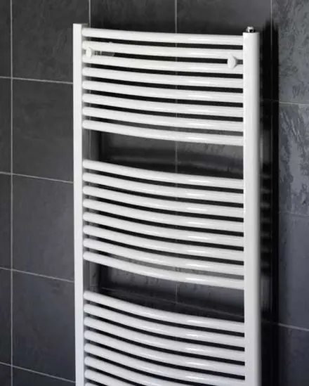 White curved towel rail on a dark tiled wall