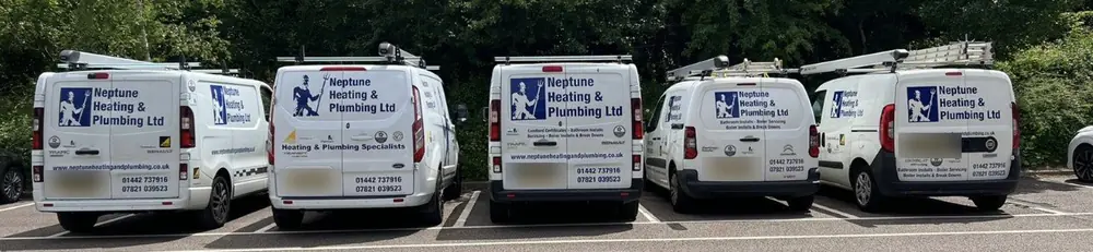 Five white Neptune vans parked in a row, number plates blurred